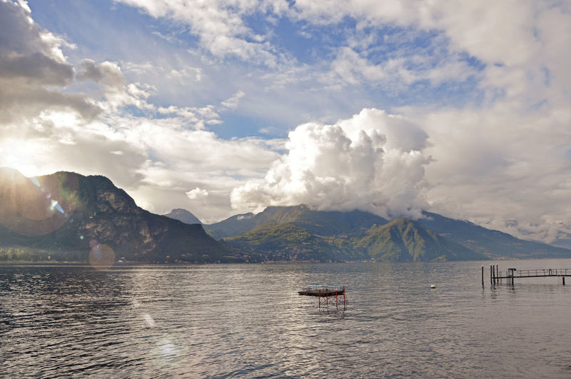 View of lake como in a cloudy day with sunshine in bellagio, a charming village in italy.