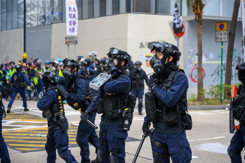 Police force standing on street