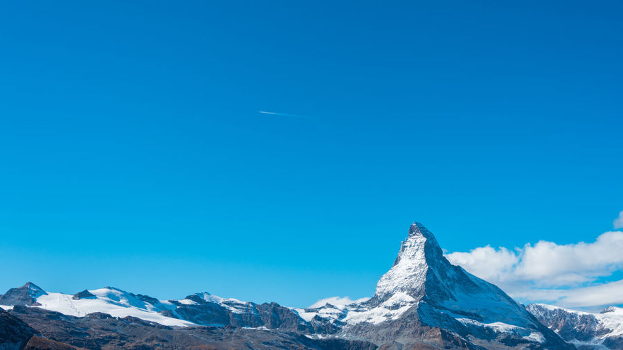 Scenic view of snowcapped mountains against clear blue sky, matterhorn, switzerland 