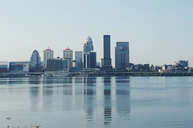 Buildings in city against clear sky