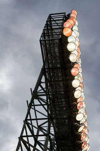 Low angle view of illuminated ferris wheel against sky