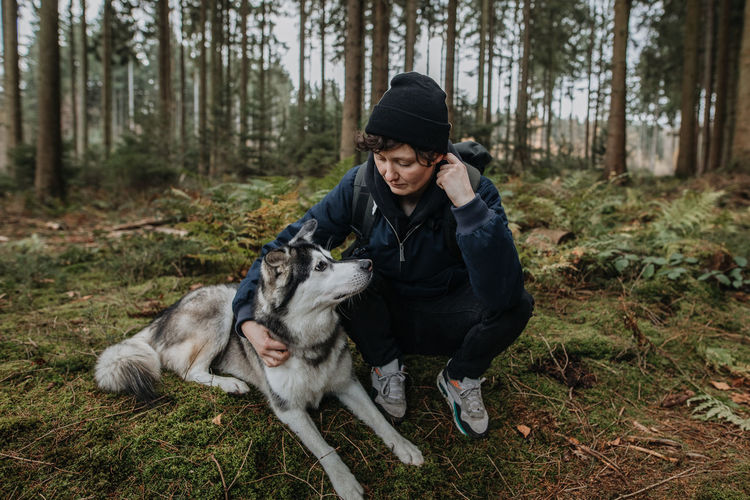 Young woman with dog in the forest