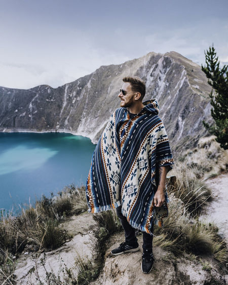 Full length of man standing on cliff