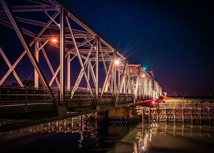 Scenic view of illuminated bridge at night