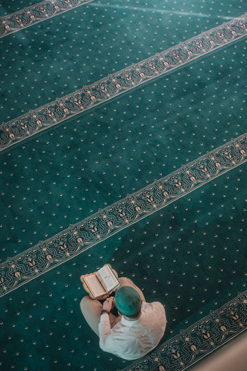 High angle view of woman lying down swimming pool
