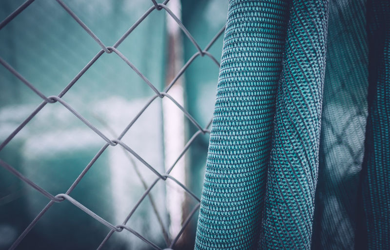 Close-up of fabric on chainlink fence