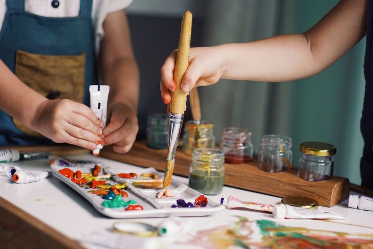 Midsection of woman painting on table