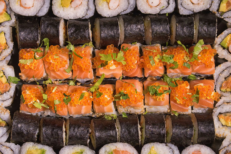 Full frame shot of sushi arranged for sale at market