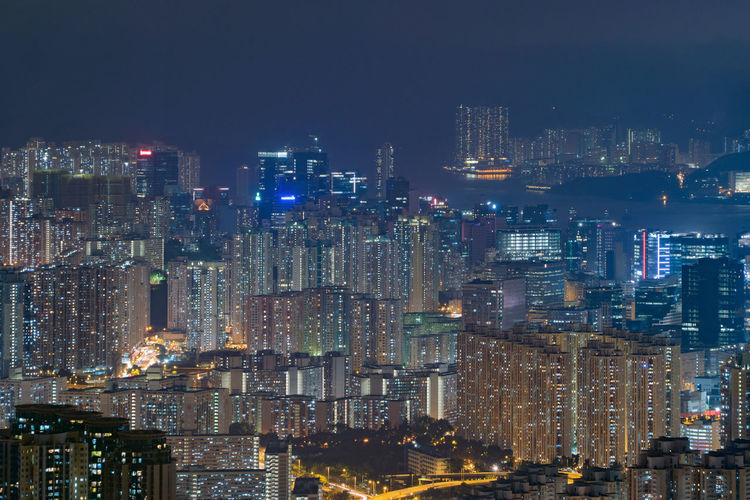 Illuminated cityscape against sky at night