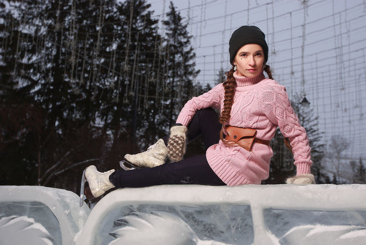 Ice skating woman sitting on the ice