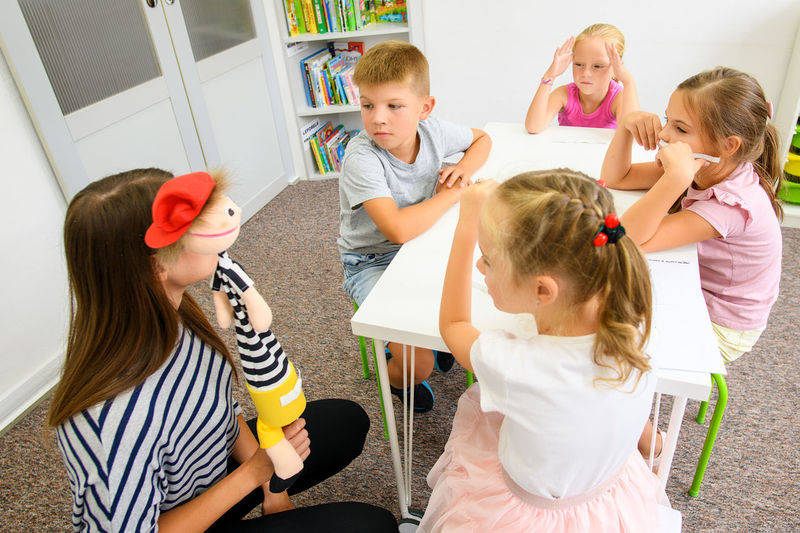 Child occupational therapy session. group of children doing playful exercises with their therapist.