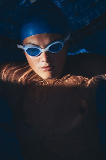 Portrait of paralympic young swimmer in a pool