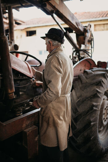 Old excavator driver in uniform tests machine.