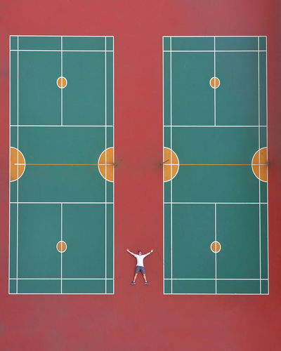 Aerial view of man lying on tennis court