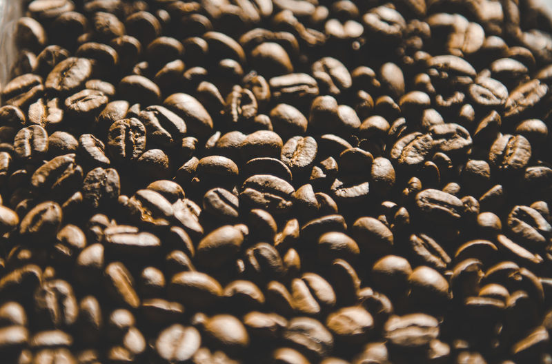 A hill of coffee beans close-up. selective focus shot background.