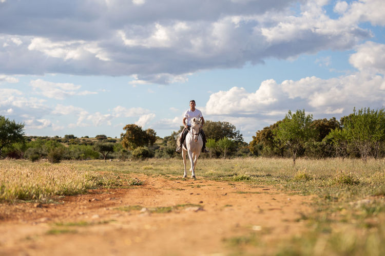 Man standing on field against sky