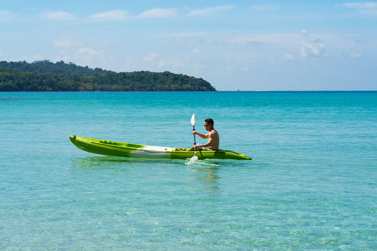Man kayaking in sea