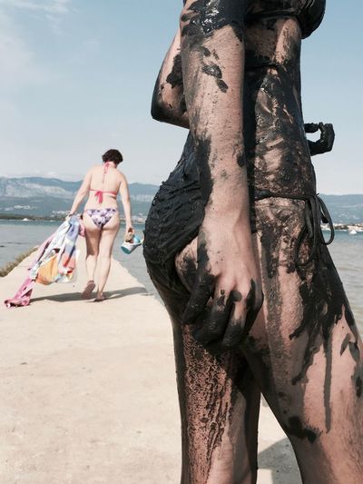 Women in bikini at beach on sunny day