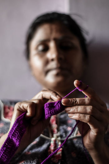 Close-up of woman knitting at home
