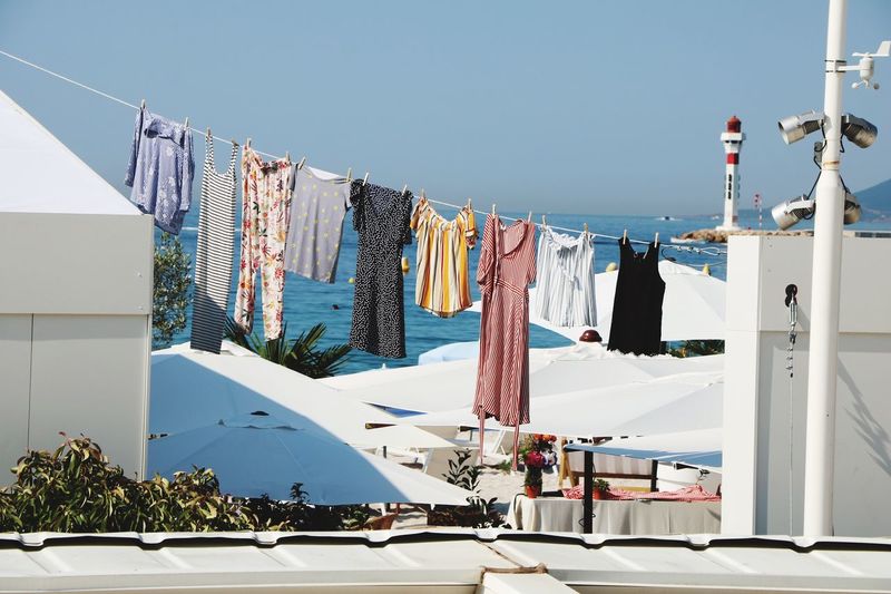 Low angle view of clothes drying on rope against buildings