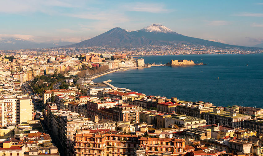 Panoramic aerial view of naples with the unusually snowy vesuvius volcano. campania, southern italy