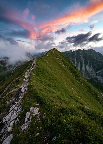 Scenic view of mountain ridge against sky during sunset