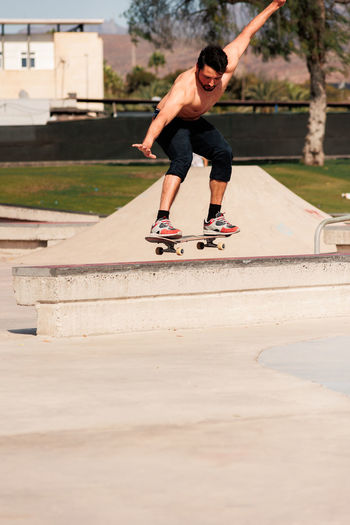 Boy doing skateboard trick on rail