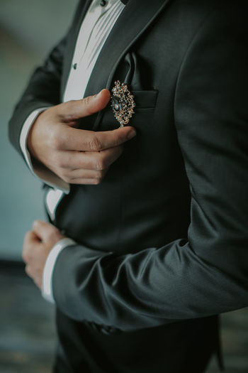 Midsection of man holding woman standing in hand