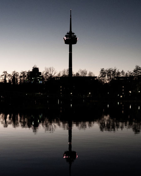 Silhouette of communications tower in city