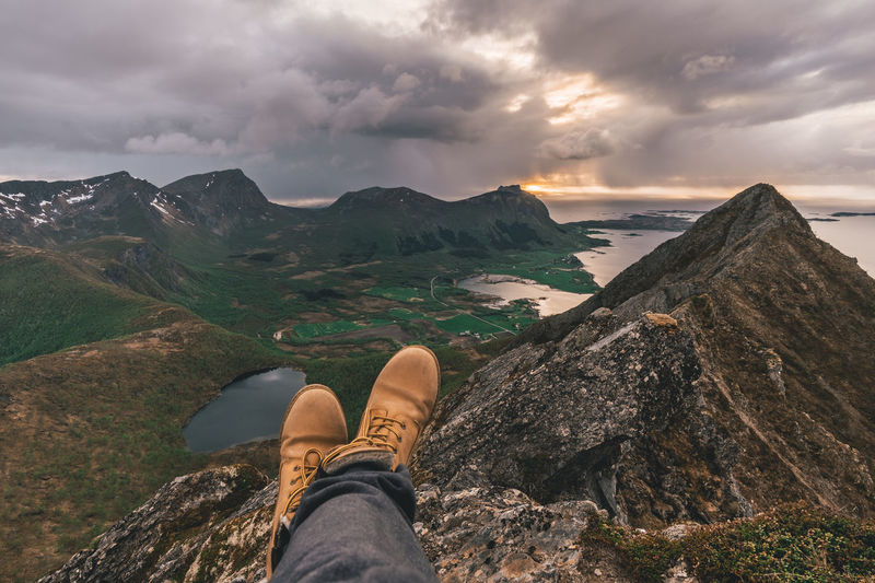Low section of man relaxing on mountain