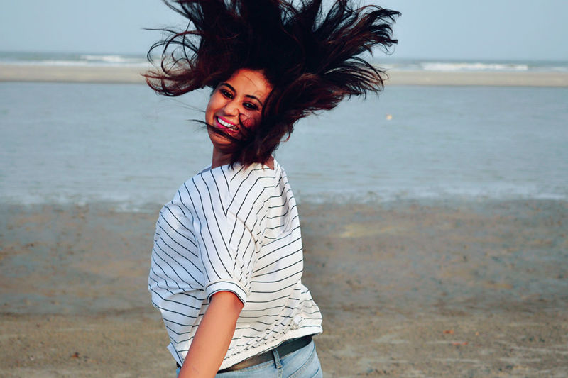 Young woman standing at beach