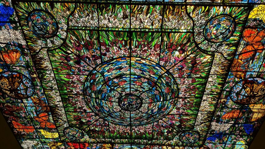 Directly below shot of multi colored glass ceiling