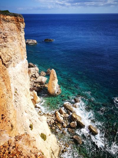 Scenic view of sea against rocks