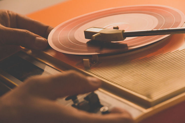 Close-up of hand playing turntable