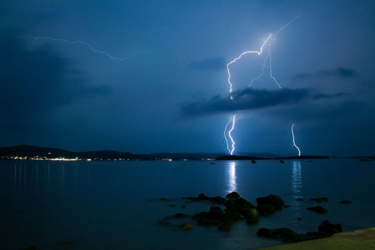 Lightning over sea against sky
