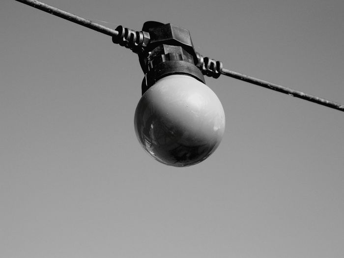 Low angle view of electric lamp against clear sky