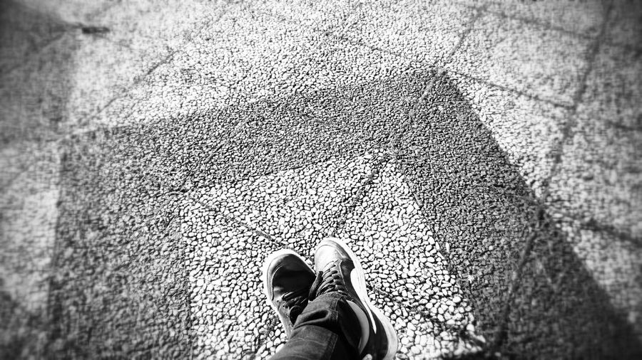 Low section of person standing on tiled floor