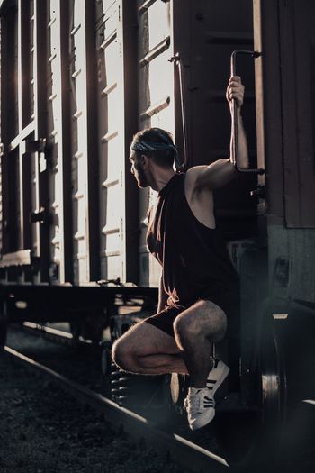 Young man sitting on cargo train