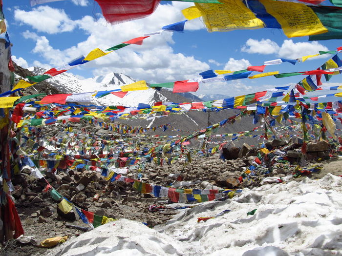 Buddhist prayer flags at mountain against sky