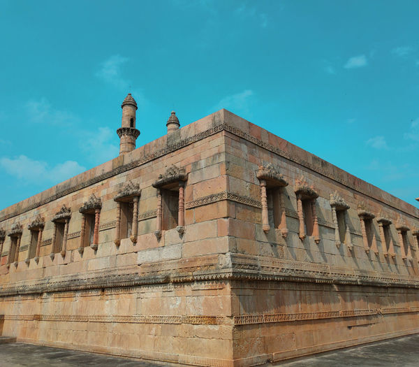 Low angle view of historical building against blue sky