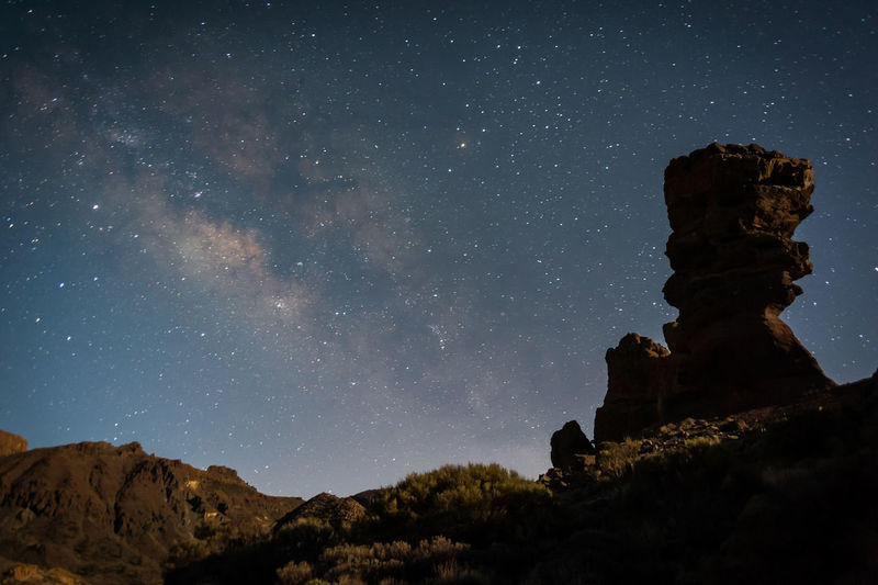 Low angle view of rocks against sky at night