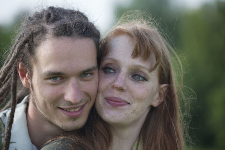 Close-up portrait of man with woman outdoors
