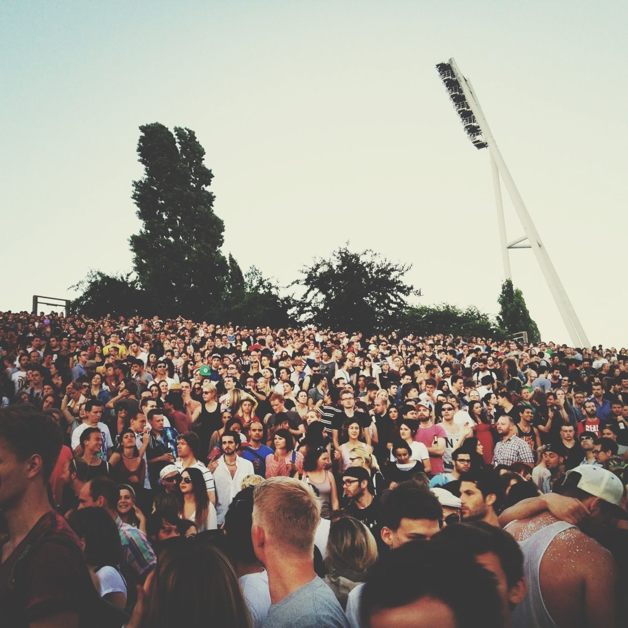 large group of people, crowd, lifestyles, men, leisure activity, person, clear sky, event, celebration, togetherness, enjoyment, fun, arts culture and entertainment, spectator, sky, music, outdoors, tree