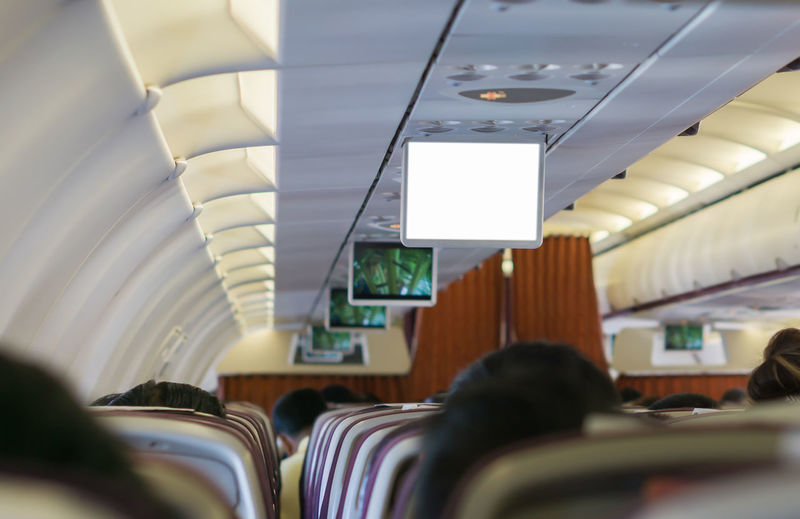 Rear view of people sitting in airplane