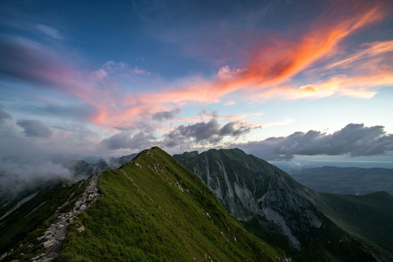 Scenic view of mountain ridge against sky during sunset