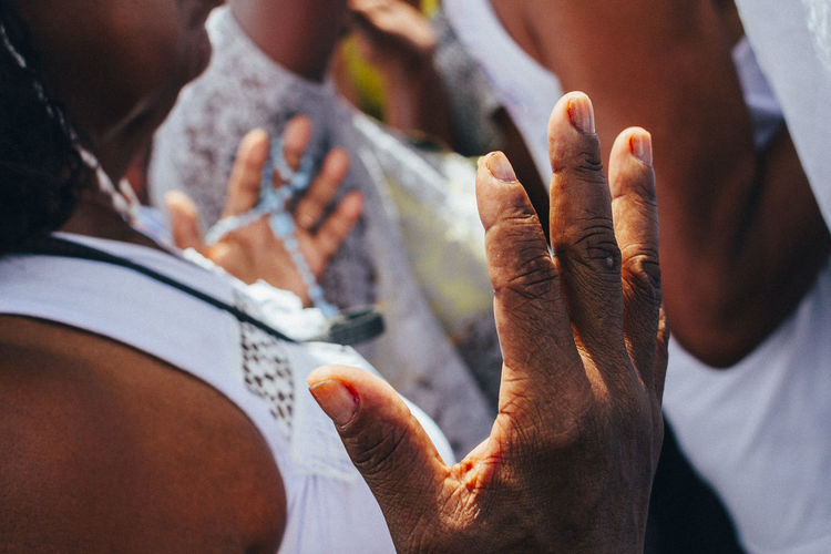 Cropped image of man praying on street