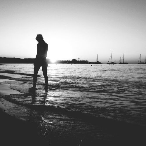 Silhouette of woman standing on beach