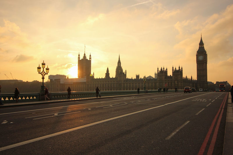 Westminster bridge and big ben against sky during sunset