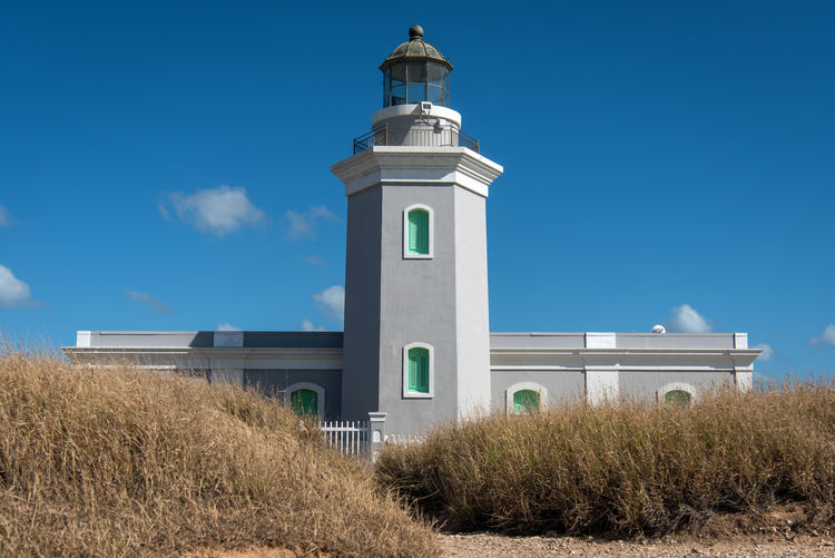 Low angle view of lighthouse on field against sky