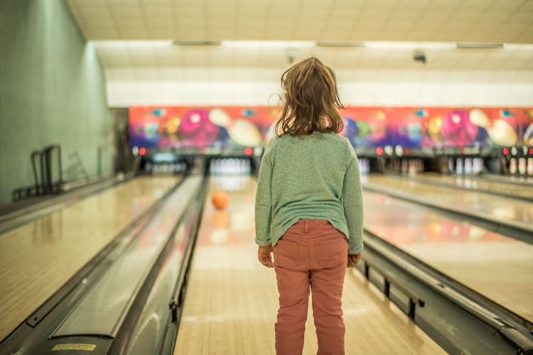 Rear view of toddler in bowling alley 